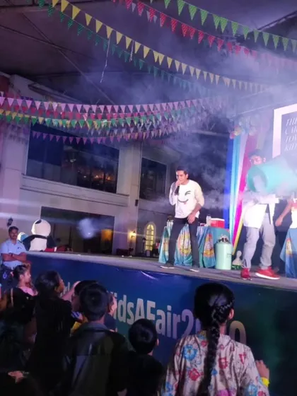A wide shot of our stage setup at a kids' carnival at Phoenix Market City. The smoke, lights, and engaged crowd show the professional and high-energy production we bring to every event.