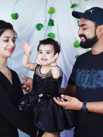 A joyful and interactive family portrait, with all three members smiling and happy.