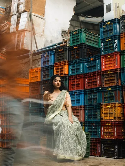 An editorial shoot set in a bustling market. I created a look that feels both contemporary and grounded, with natural curls and makeup that enhances the model's features against the vibrant, textured background.