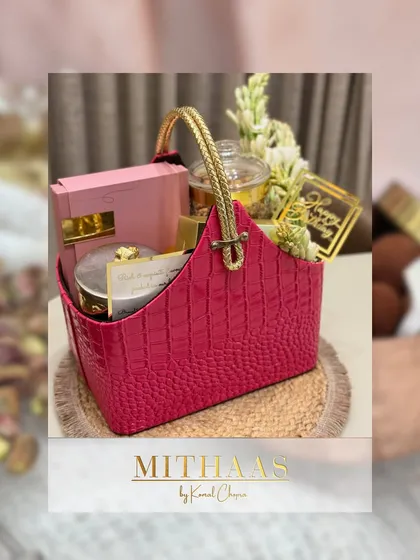 This vibrant pink basket was curated with a mix of treats and fresh tuberoses. It demonstrates how you can add personal touches like fresh flowers to make your hamper even more special.