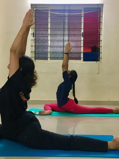 Students practicing Ekapadasana (One-Legged Pigeon Pose) in unison. This pose is a fantastic hip opener and helps release stored stress and emotion.