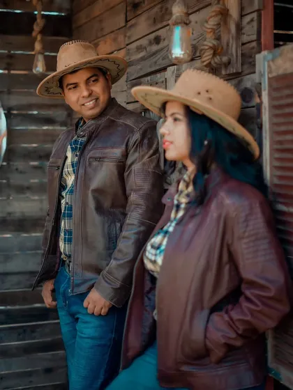 A candid moment from a Western-themed shoot. Aditya and Priyanka share a look, perfectly styled for their unique pre-wedding concept.