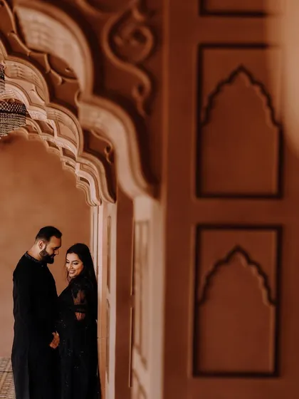 A beautiful moment from a pre-wedding shoot in a stunning architectural location. The couple's look is classic and coordinated.