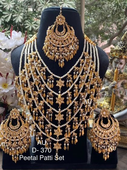 A traditional gold-plated 'Peetal Patti' set, a classic choice for Punjabi brides.