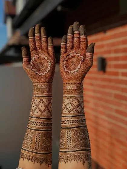 This full arm design for bride Hafsa features her and her partner's names hidden within the pattern. It's a special way to personalize your bridal henna.
