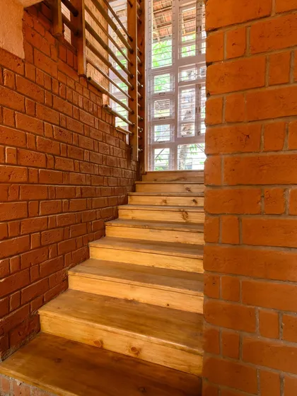 I'm always looking for the details that guide you through a home. This wooden staircase against the exposed brick wall creates a beautiful textural contrast. My goal was to capture the light drawing you upwards, showing the connection between the different levels of the house.