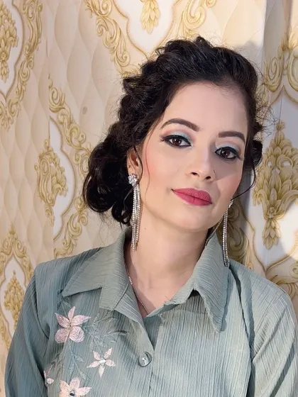 A fresh and modern party look. I created a soft, curly updo with face-framing pieces and paired it with a light blue-toned smokey eye and a pink lip.