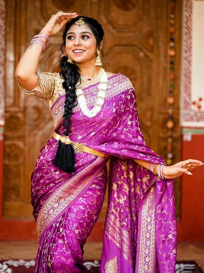 This stunning purple Banarasi silk saree is perfect for a wedding guest or for a bride's pre-wedding functions. The intricate gold weaving and the rich colour make it a timeless piece.