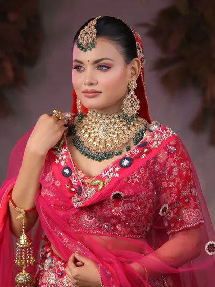 From learners to artists. Our students master the art of bridal makeup, creating breathtaking looks like this one with a vibrant pink lehenga and heavy kundan jewelry.