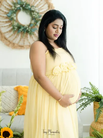 Surrounded by sunflowers, this mother-to-be is a picture of warmth and happiness. The yellow tones in the decor and her dress create a cohesive, cheerful look.
