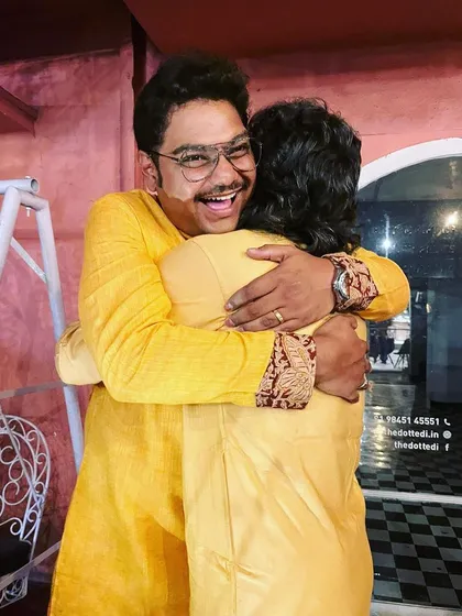 A joyful hug with a fellow musician after a successful concert.