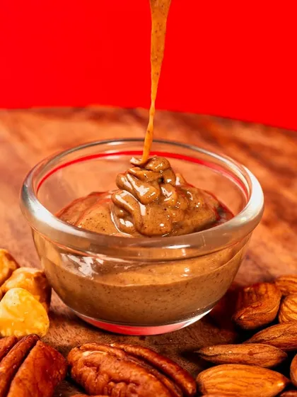 A shot capturing a thick stream of chocolate hazelnut spread being poured. The motion and texture of the cascading chocolate are the heroes of this image.