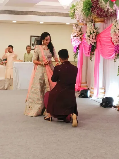 The groom proposing to his bride during their ring ceremony.