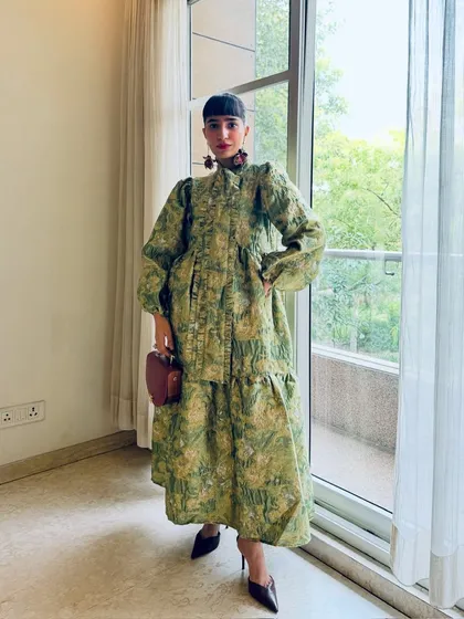 A full-length shot of my green floral brocade dress, a piece that is both romantic and structured.