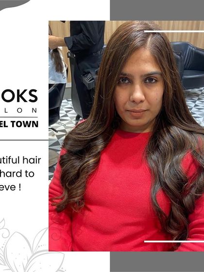 A frontal view of the client's new subtle hair color, showing how it enhances her features and gives her hair a healthy glow.