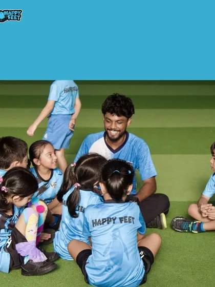 A happy huddle with one of our coaches! We believe in creating a strong bond with every child, making them feel heard and encouraged. Our coaches sit with the kids, listen to their stories, and make learning a joyful, shared experience.