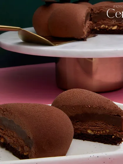 Slices of the Chocolate Dreams entremet, revealing the indulgent layers of chocolate and caramel ganache with hints of hazelnut.