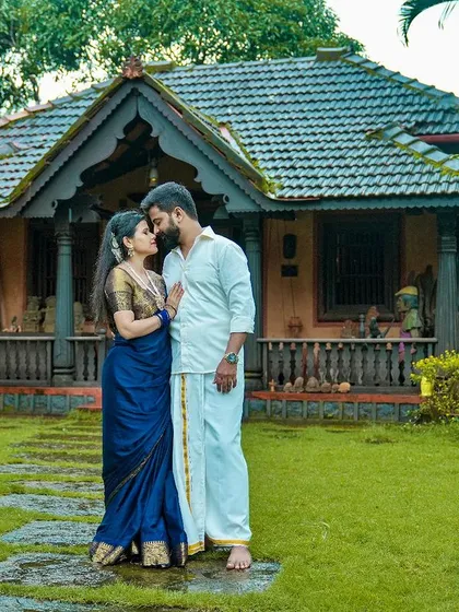 A classic pre-wedding portrait in front of a traditional Mangalorean home. We love incorporating the unique architecture and heritage of the Karavali coast into your story.