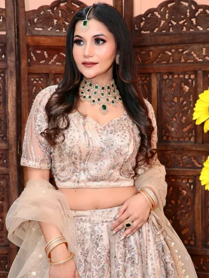 Another angle of the beige and silver lehenga, showing the delicate net dupatta and the beautiful fall of the skirt.