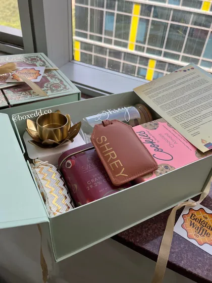 A personalized gift for an employee at The Belgian Waffle Co. This hamper includes a custom-named luggage tag and bottle, showing our commitment to making every gift feel personal.