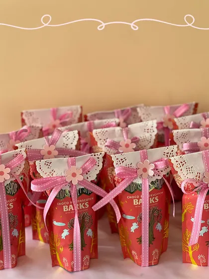 We individually wrapped each pack of chocolate barks with a doily and a pink flower-adorned ribbon for an extra special touch.