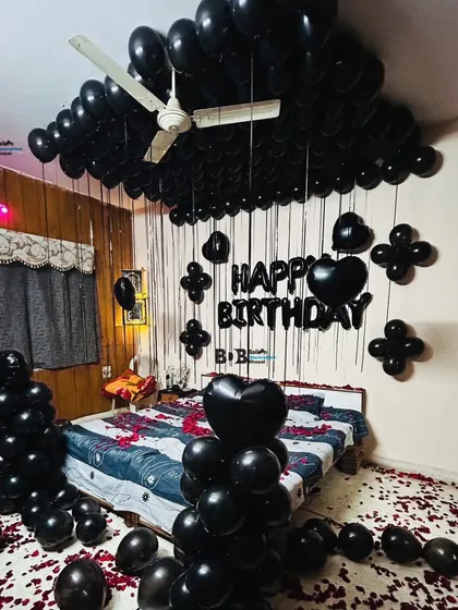 Another look at the popular all-black theme, this time showing how the black balloons completely cover the ceiling. This creates a dramatic and stylish atmosphere for a unique birthday celebration.