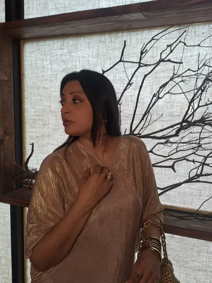 A thoughtful pose in this beautiful gold outfit. The right outfit can make you feel like you're in your own world.