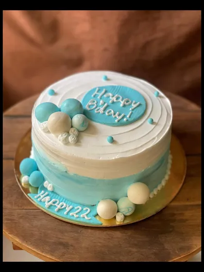 A side view of the minimal blue and white birthday cake, showing the two-tone effect.