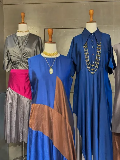 A collection of modern, tailored silhouettes. I love the color-blocked blue and brown tunic and the chic grey pleated skirt with a pop of pink.