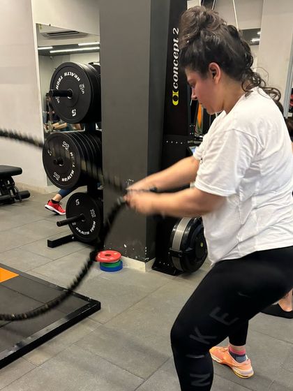 A member works the battle ropes during a high-intensity interval training session, a great way to build cardiovascular endurance and power.