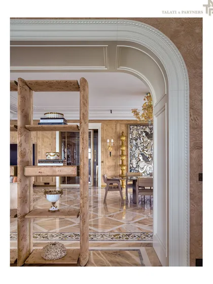 An arched doorway frames a view into a room with intricate marble flooring and classic architectural details. This image is from one of our projects featured in Architectural Digest's prestigious AD100 list, recognizing our firm's legacy of design excellence.