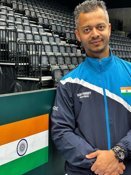 Bleed Blue. A quiet moment of reflection by the court, wearing my official 'Yash Pandey Physio' Team India jacket. It's an honor to have my name next to the Indian flag.