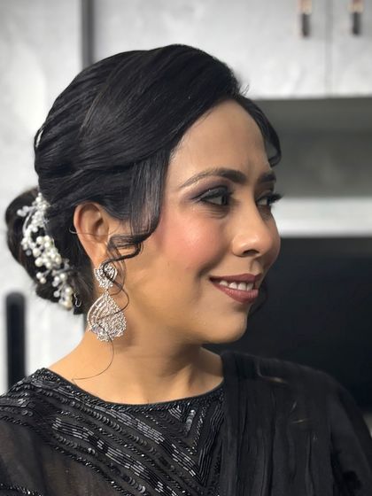 A classic party makeup look featuring a shimmery smokey eye and a beautiful updo. This is a timeless choice for any evening event.