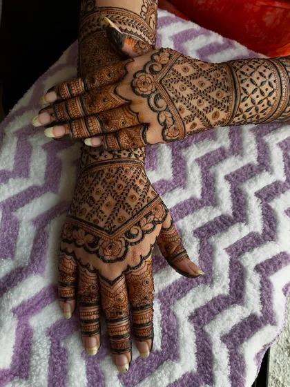 A close-up of the engagement mehendi, highlighting the beautiful rose-inspired patterns on the back of the hand.