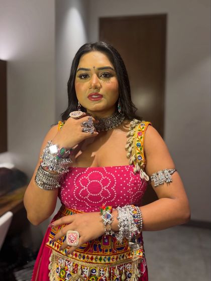 All about the accessories! This Navratri look is completed with oxidized silver jewelry, from the choker and bangles to the rings, giving it an authentic and festive feel.