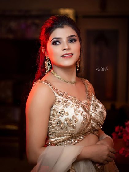 An elegant bridal portrait with dramatic lighting. The bride looks up and away, creating a sense of aspiration and hope in this beautifully lit shot.