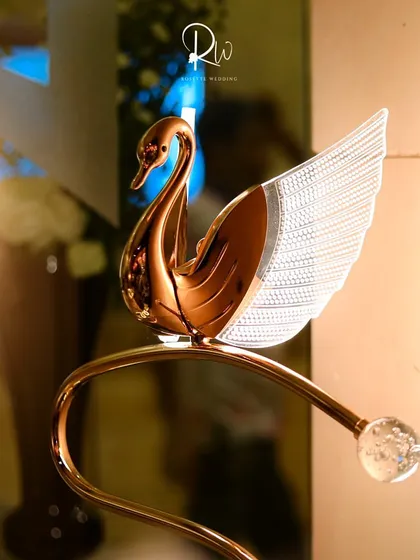 A decorative golden swan figurine, an example of the small, elegant props I use to enhance a theme.