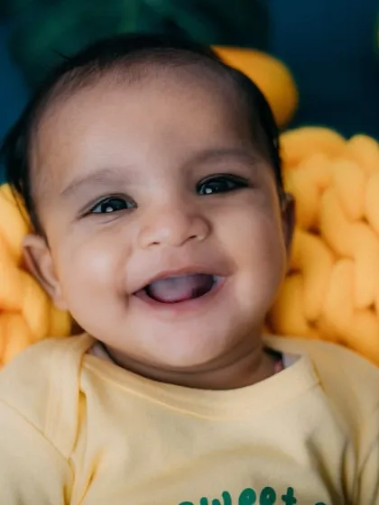 As sweet as a mango! This 4-month-old's happy smile is absolutely contagious. Fruit-themed shoots are a fun way to celebrate a milestone.