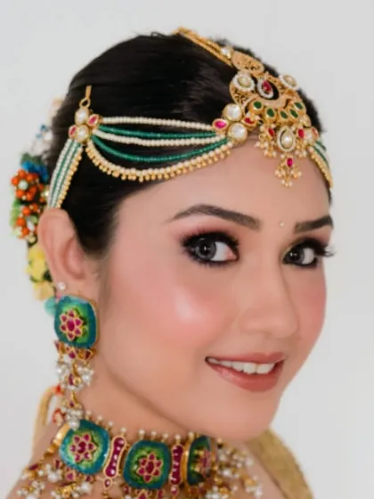 A final shot of the client's radiant traditional look. The classic bun is the perfect hairstyle to complete this elegant ensemble.
