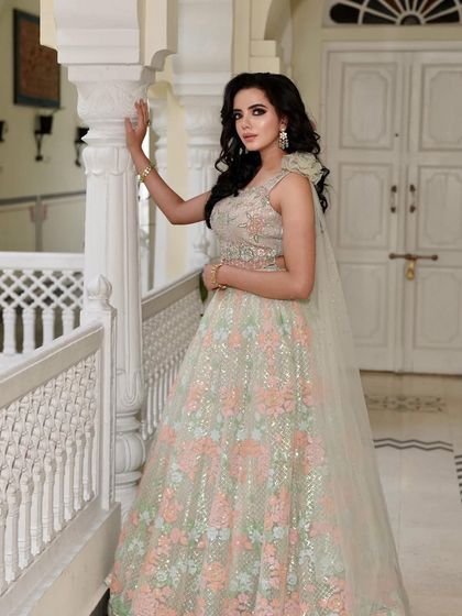 Another look at our summer-hued floral lehenga. The soft pastel colors and delicate embroidery create a romantic and feminine look, perfect for a garden wedding or mehendi ceremony.