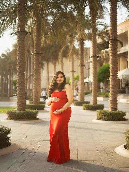 For this shot, we swapped the dramatic tulle gown for a sleek, bodycon red dress. It shows how a simple change of outfit can create a completely different, more modern vibe in the same beautiful outdoor location.