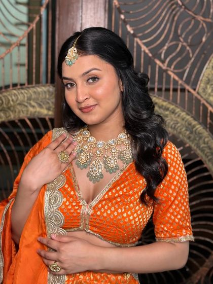 A beautiful portrait that showcases the soft, peachy makeup and the stunning traditional jewelry.