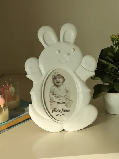 The playful white bunny photo frame, designed to bring a sense of joy and innocence to your child's room. Its clean and simple design fits beautifully in any nursery decor.