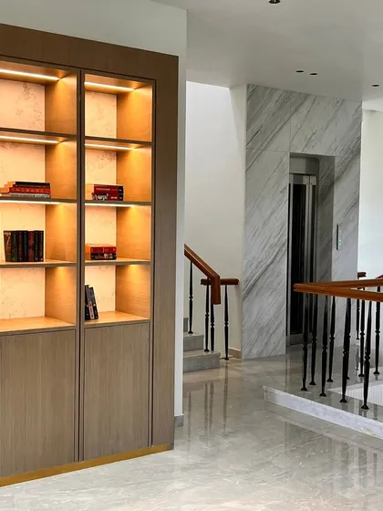 Our custom-built library and display unit, designed to fit perfectly within an architectural niche in a luxury home. The piece features a warm wood finish, brass detailing, and integrated lighting to highlight the client's collection.