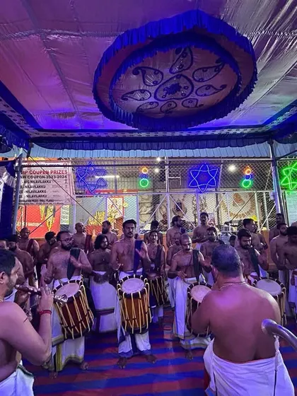 A wide view of our Panchari Melam performance under the vibrant lights of the temple, led by the esteemed Shri Peruvanam Sankaranarayanan Marar.