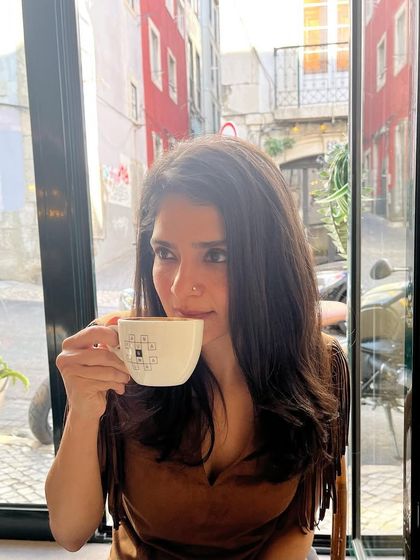 Sipping on a warm drink after a delicious vegan meal. Taking a moment to savor the flavors and enjoy the atmosphere of this beautiful cafe in Lisbon.