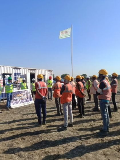A safety briefing session in progress at a project site. These daily meetings are crucial for reinforcing safety protocols and ensuring every team member is aware of the day's tasks and potential hazards, contributing to a secure work environment.