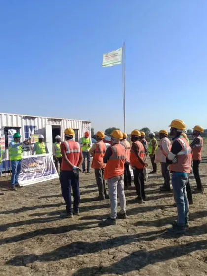 A safety meeting in progress at a construction site. Open communication and continuous learning are key to proactively mitigating risks and maintaining our high safety standards.