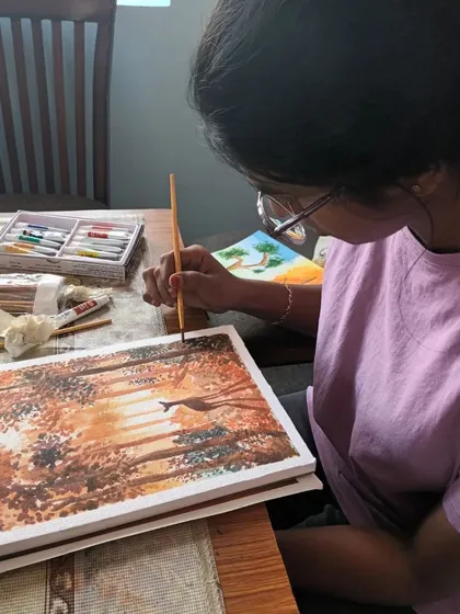 Here is my offline student Harshni, carefully adding details to her watercolour landscape. She is learning to layer colours to create depth and light.