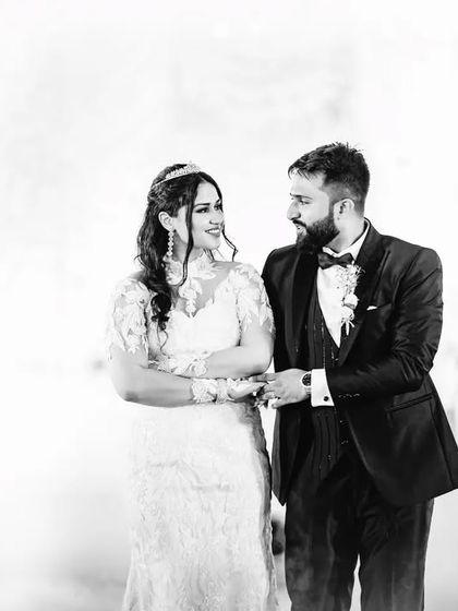 A black and white candid of the couple during their first dance. The high-key lighting and soft focus create a dreamy and ethereal atmosphere.
